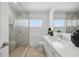 Modern bathroom with a walk-in shower, window, and sleek vanity at 3528 Casablanca Ave, St Petersburg, FL 33706