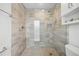 Sleek walk-in shower with neutral tiling, a shower niche and modern fixtures at 3528 Casablanca Ave, St Petersburg, FL 33706
