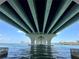 A beautiful view from under a modern bridge showcasing blue skies and tropical residences in the distance at 3528 Casablanca Ave, St Petersburg, FL 33706
