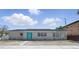 Charming home featuring a bright blue door and well-maintained landscaping, creating a welcoming curb appeal at 3528 Casablanca Ave, St Petersburg, FL 33706