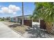 Charming home featuring meticulous gravel landscaping, a privacy fence and vibrant palm trees at 3528 Casablanca Ave, St Petersburg, FL 33706