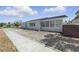 Single-story home featuring meticulous gravel landscaping and a bright blue front door at 3528 Casablanca Ave, St Petersburg, FL 33706