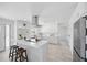 Modern kitchen featuring white cabinets, stainless steel appliances, and a spacious island with bar seating at 3528 Casablanca Ave, St Petersburg, FL 33706
