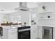Bright, updated kitchen featuring white cabinetry, stainless steel appliances, and an island with bar seating at 3528 Casablanca Ave, St Petersburg, FL 33706