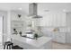 Sleek kitchen boasting white cabinetry, a stainless steel range hood, and a bright, functional design at 3528 Casablanca Ave, St Petersburg, FL 33706