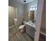 Bathroom featuring gray vanity, tile floor, and laundry area with washer and dryer at 8114 Oak Trace Way # C, Tampa, FL 33634