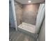 Clean bathroom featuring a bathtub with a shower and modern gray tile surround at 8114 Oak Trace Way # C, Tampa, FL 33634