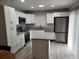 Modern kitchen with white cabinets, stainless steel appliances, and granite countertops at 8114 Oak Trace Way # C, Tampa, FL 33634