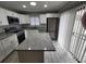 Bright kitchen featuring white cabinets, granite countertops, and stainless steel appliances at 8114 Oak Trace Way # C, Tampa, FL 33634