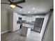 Well-lit kitchen with granite countertops, white cabinets, and stainless steel appliances at 8114 Oak Trace Way # C, Tampa, FL 33634