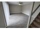 Open concept living room featuring neutral paint, wood-look tile flooring, and stair access at 8114 Oak Trace Way # C, Tampa, FL 33634
