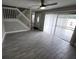 Inviting living room with wood-look tile flooring, neutral paint, and stair access at 8114 Oak Trace Way # C, Tampa, FL 33634