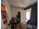 Small room with a dark table, window with curtain, door, and tile floor, showing basic furnishings at 3613 Deleuil Ave, Tampa, FL 33610