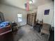Bedroom with a bed frame, an American flag, and a window offering natural light at 3613 Deleuil Ave, Tampa, FL 33610