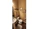Cozy half bathroom featuring a pedestal sink, tile flooring, and warm wall color at 7620 Tangle Rush Dr, Gibsonton, FL 33534