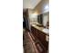 Large bathroom featuring double sinks, a long vanity, and a large mirror at 7620 Tangle Rush Dr, Gibsonton, FL 33534