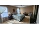 Comfortable bedroom featuring carpet, a ceiling fan, and two windows for natural light at 7620 Tangle Rush Dr, Gibsonton, FL 33534