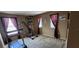 A carpeted exercise room with large windows with an exercise machine and treadmill at 7620 Tangle Rush Dr, Gibsonton, FL 33534