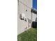 House exterior showing electrical components, water meter and trash can at 7620 Tangle Rush Dr, Gibsonton, FL 33534