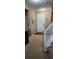 Bright foyer with carpet flooring, white front door, and staircase access at 7620 Tangle Rush Dr, Gibsonton, FL 33534