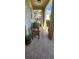 Inviting front porch with a wooden bench and tiled flooring at 7620 Tangle Rush Dr, Gibsonton, FL 33534