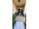 Charming front porch with a tiled floor and lush potted plants at 7620 Tangle Rush Dr, Gibsonton, FL 33534