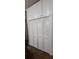 Garage space with a painted brick wall, storage cabinets, and closet at 7620 Tangle Rush Dr, Gibsonton, FL 33534