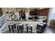Open kitchen area with bar seating featuring granite countertops and modern dark wood cabinets at 7620 Tangle Rush Dr, Gibsonton, FL 33534