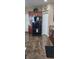 The kitchen has a side-by-side refrigerator, tile flooring, and upper wood cabinets at 7620 Tangle Rush Dr, Gibsonton, FL 33534