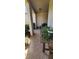 Covered patio area with tiled flooring, ideal for outdoor relaxation and potted plants at 7620 Tangle Rush Dr, Gibsonton, FL 33534