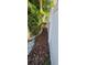 Side yard walkway with white fence and landscaped with mulch and rocks at 7620 Tangle Rush Dr, Gibsonton, FL 33534