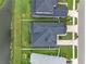 Aerial view of home showcasing the roof, backyard, fence, and adjacent pond at 7163 Talamore Dr, Wesley Chapel, FL 33545