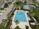 Overhead view of community pool surrounded by trees and featuring shaded tables at 7163 Talamore Dr, Wesley Chapel, FL 33545