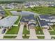 Expansive aerial view showcases the home's location near a pond and neighborhood amenities at 7163 Talamore Dr, Wesley Chapel, FL 33545