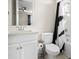 Bathroom with white vanity, modern fixtures, and a tub-shower combo with a black and white curtain at 7163 Talamore Dr, Wesley Chapel, FL 33545