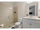 Bathroom with glass shower, tiled walls, toilet, large mirror and white vanity with a sink at 7163 Talamore Dr, Wesley Chapel, FL 33545