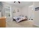 Cozy bedroom featuring a bed with floral bedding, a dresser and a window with natural light at 7163 Talamore Dr, Wesley Chapel, FL 33545