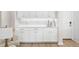 Chic butler's pantry featuring white cabinetry, a quartz countertop, stylish backsplash, and modern fixtures at 7163 Talamore Dr, Wesley Chapel, FL 33545