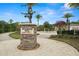 Beautiful Promenade Park sign with statue and water feature in a well-maintained community at 7163 Talamore Dr, Wesley Chapel, FL 33545