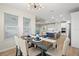 Inviting dining area with modern lighting and a view into the open kitchen and living space at 7163 Talamore Dr, Wesley Chapel, FL 33545