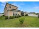 Exterior view of the house showcasing the backyard, fence, and well-maintained lawn at 7163 Talamore Dr, Wesley Chapel, FL 33545