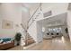 Spacious foyer featuring a staircase and an open view into the living room at 7163 Talamore Dr, Wesley Chapel, FL 33545