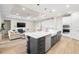 Spacious open-concept kitchen and living area with a large center island, stainless appliances, and ample cabinet space at 7163 Talamore Dr, Wesley Chapel, FL 33545