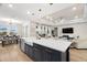 Bright open-concept kitchen and living area, featuring a large island with a farmhouse sink and modern pendant lighting at 7163 Talamore Dr, Wesley Chapel, FL 33545