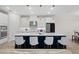 Modern kitchen with stainless steel appliances and an island with bar stool seating at 7163 Talamore Dr, Wesley Chapel, FL 33545
