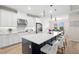 Well-equipped kitchen with stainless steel appliances, ample storage, and a center island with seating at 7163 Talamore Dr, Wesley Chapel, FL 33545