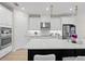 Modern kitchen boasts white cabinetry, stainless steel appliances, and a stylish center island with quartz countertop at 7163 Talamore Dr, Wesley Chapel, FL 33545