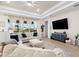 Bright living room featuring large windows, stylish curtains, and a comfortable seating arrangement, creating a relaxing space at 7163 Talamore Dr, Wesley Chapel, FL 33545