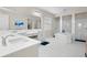 Bright, spacious main bathroom featuring dual vanities, a soaking tub and walk-in shower at 7163 Talamore Dr, Wesley Chapel, FL 33545