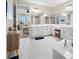 Modern main bathroom featuring dual vanities, a soaking tub, and a walk-in shower at 7163 Talamore Dr, Wesley Chapel, FL 33545